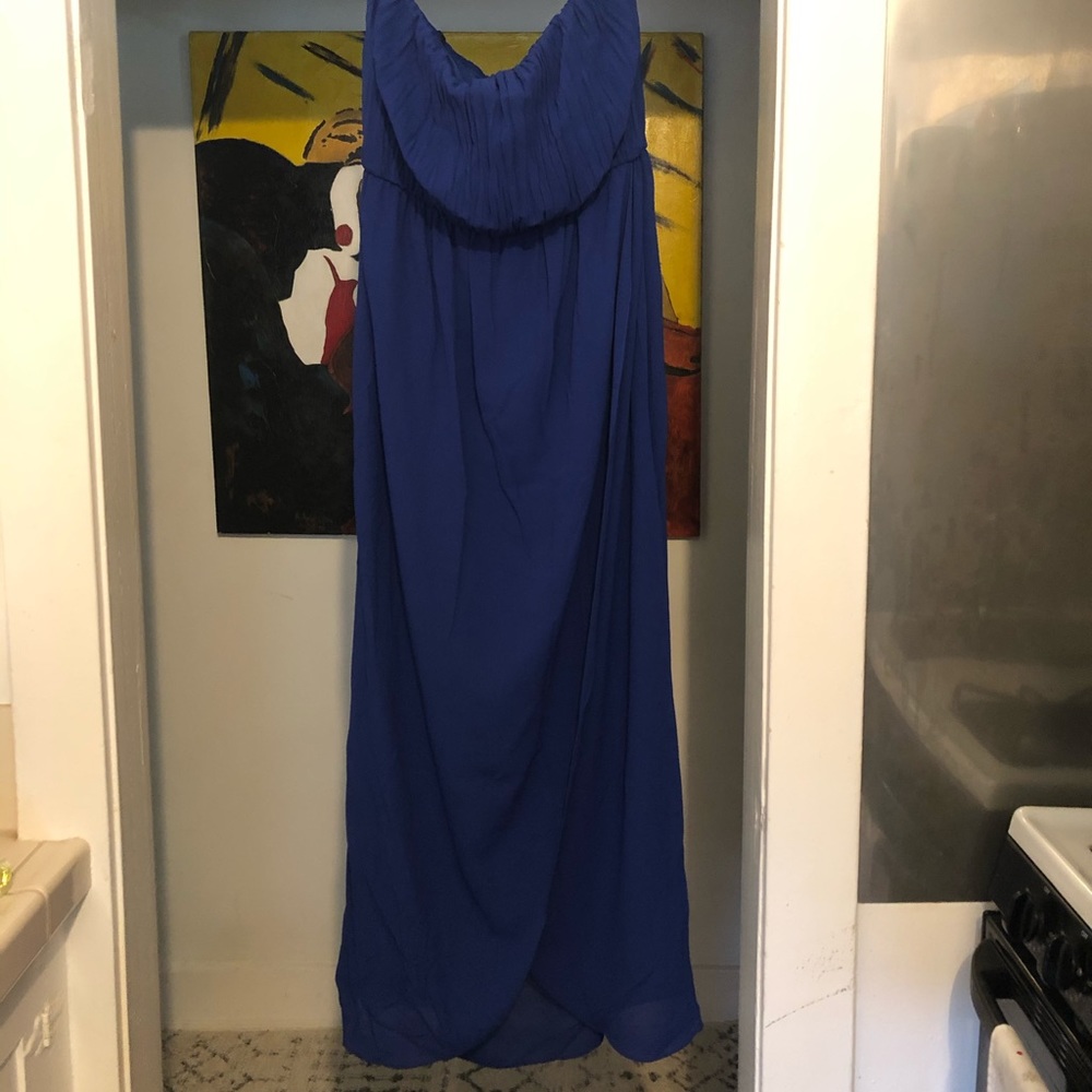 Blue floor length strapless dress.